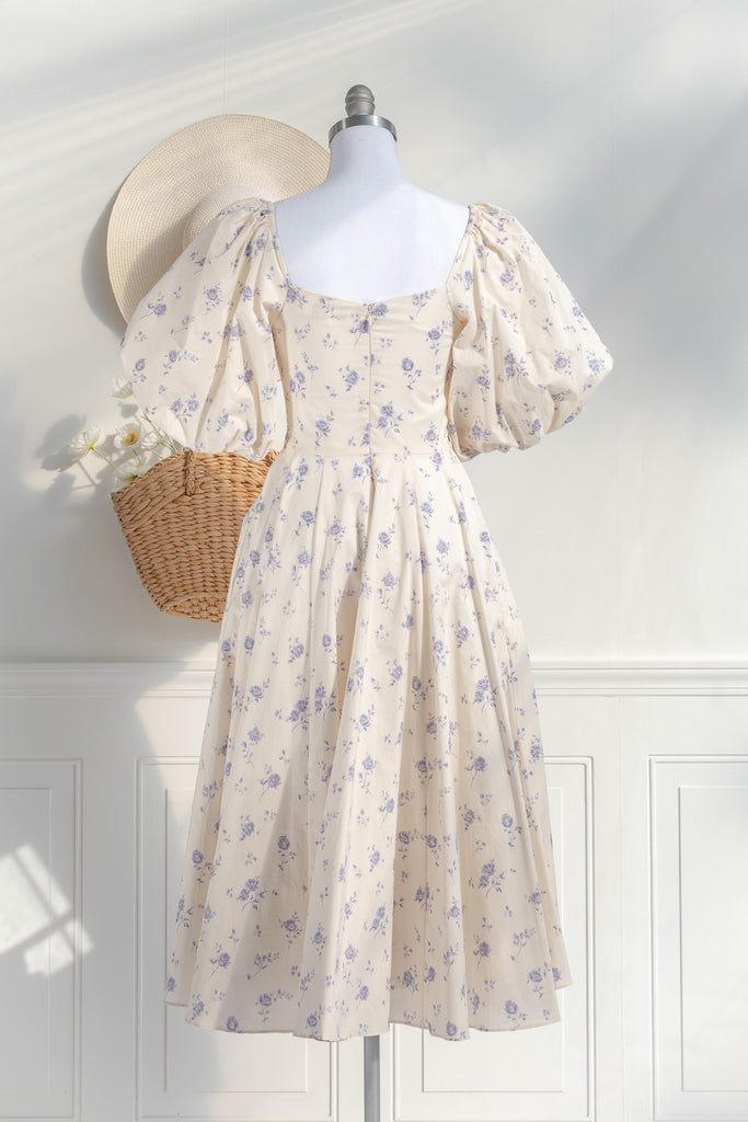 cottagecore dress - this dress is a flowing, romantic garment characterized by soft hues and delicate details that inspire feelings of nostalgia and whimsy. These dresses draw inspiration from the idyllic charm of life in a quaint, rural cottage from a bygone era as well as french country cottage charm. back view. 