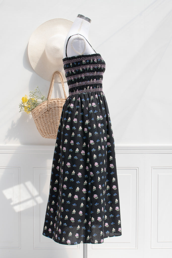 cotton cottagecore dress - a black floral strap dress with ruched bodice, pockets, and an a line skirt. side view. 