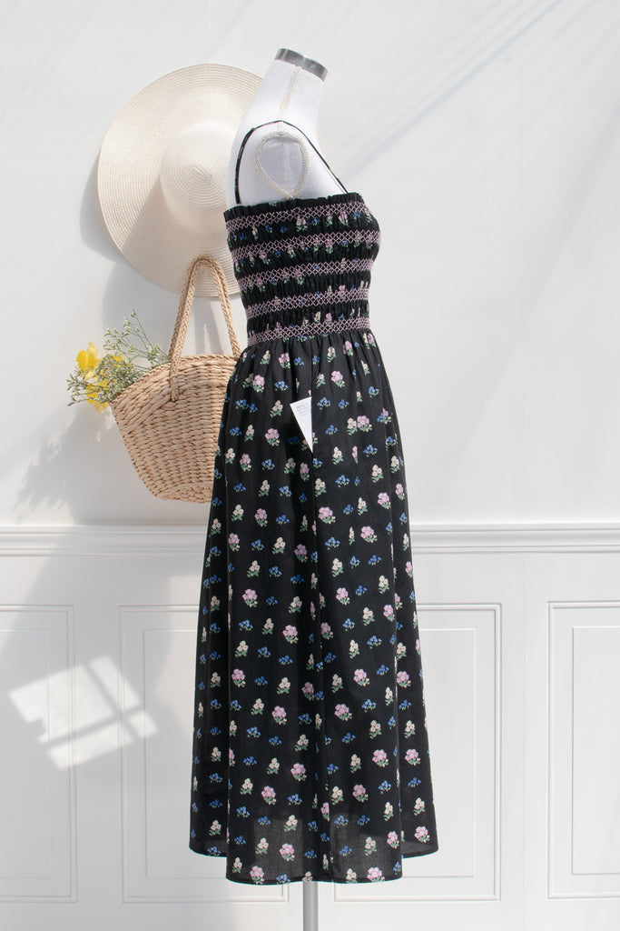 cotton cottagecore dress - a black floral strap dress with ruched bodice, pockets, and an a line skirt. side pocket view. 