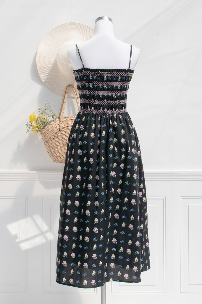 cotton cottagecore dress - a black floral strap dress with ruched bodice, pockets, and an a line skirt. back view. 
