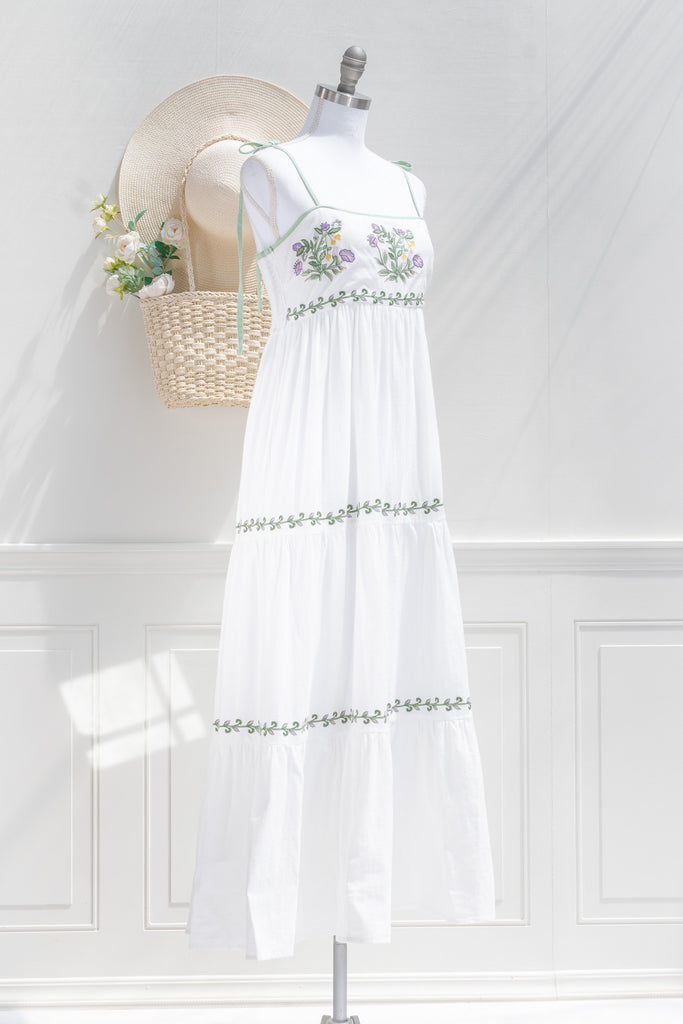 cottagecore dress - a lovely white a-line dress with tiered skirt, embroidered bust, and spaghetti straps. 3/4 side view of pretty dress. 