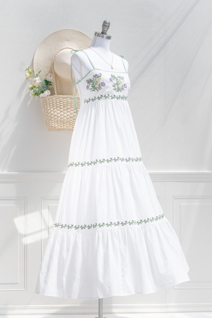 cottagecore dress - a lovely white a-line dress with tiered skirt, embroidered bust, and spaghetti straps. 3/4 view of pretty dress. 