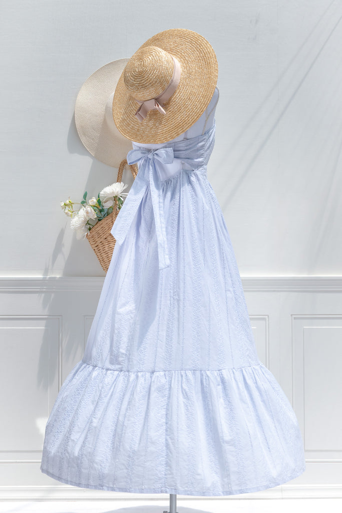 a 100% cotton dress featuring romantic eyelet lace fabric, a higher waistline for a regency-inspired silhouette, a flattering square neckline. A perfect cottagecore and castlecore aesthetic. back side view. amantine.