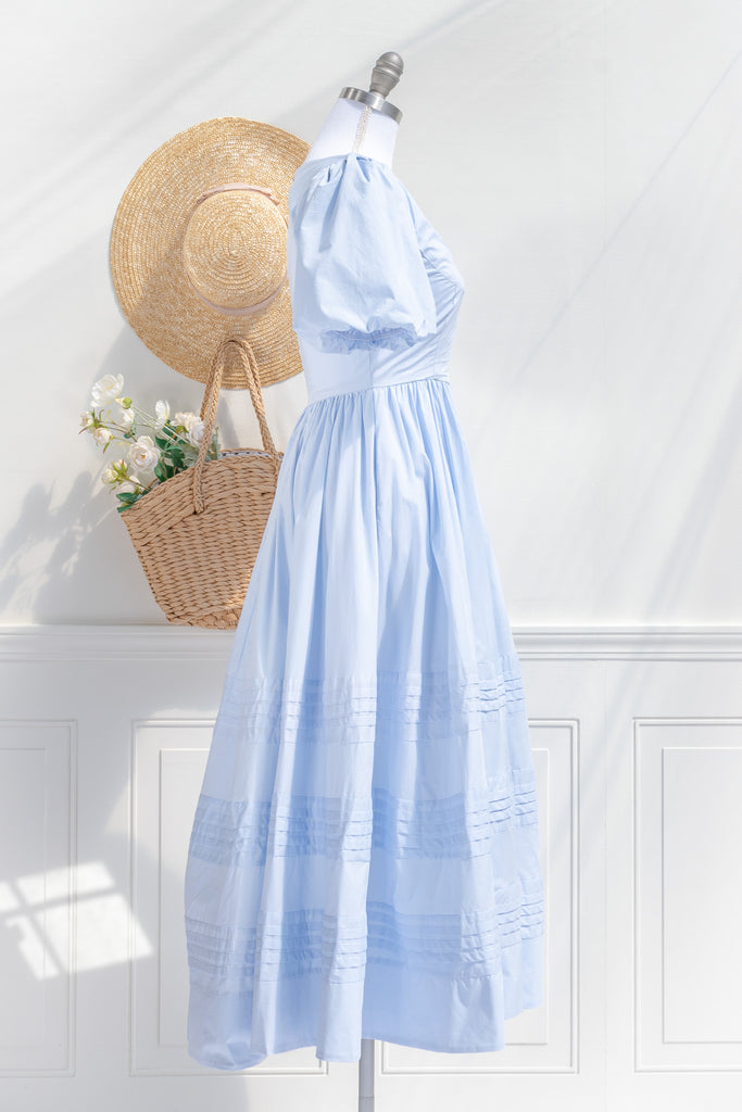 blue cottagecore dress - soft cotton dress with round neckline, puff sleeves, side pockets, and a long a line skirt. perfect for brunches in springtime. second side view. 