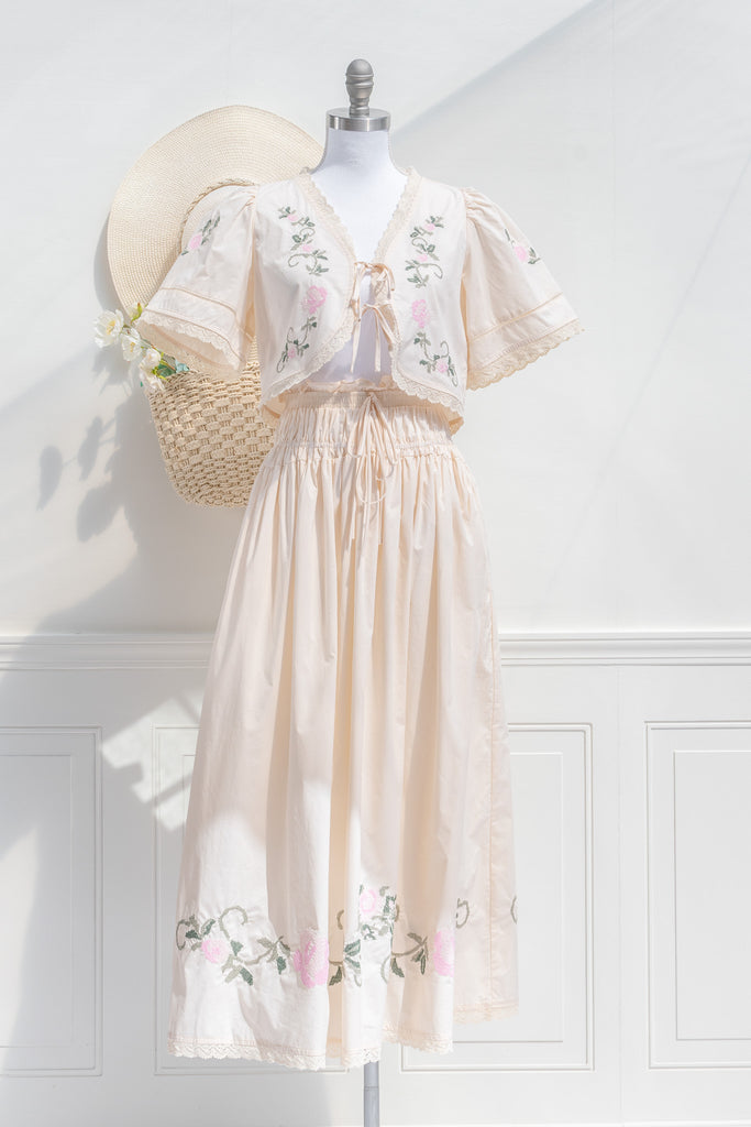 a cottagecore style two piece set with floral details, delicate lace, front bow closures, and pointelle embroidery. perfect for a beach vacation cottagecore style. front view. 