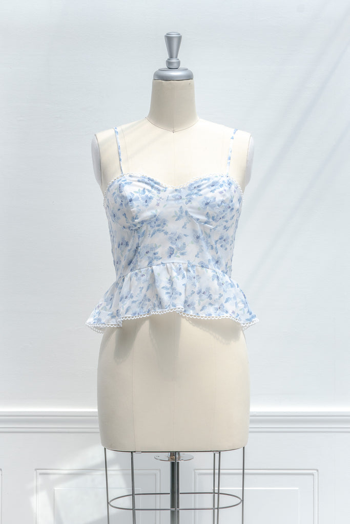 cute floral tops - french girl feminine style - a white and blue floral spaghetti strap blouse. front view. 