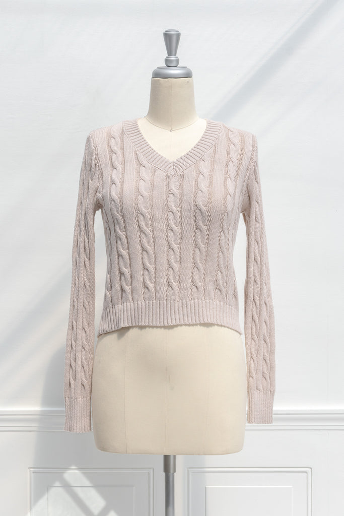 cute sweaters for fall - a classic taupe cable knit v neck pull over sweater. front view.