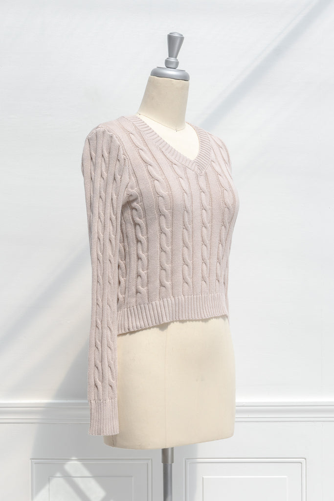 cute sweaters for fall - a classic taupe cable knit v neck pull over sweater. side view.