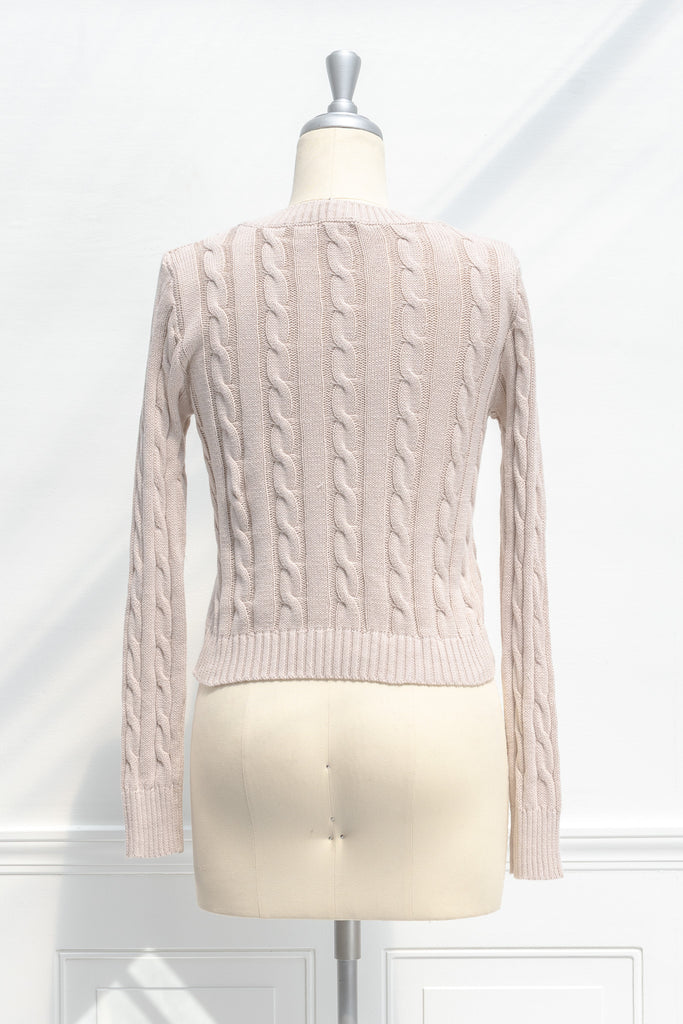 cute sweaters for fall - a classic taupe cable knit v neck pull over sweater. back view.