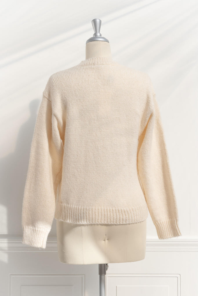 a cute sweater with a crew neckline, long sleeves, button down closure, and a teddy bear print with a 3d bow detail. back view. amantine. 