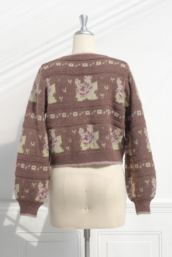 cute sweaters for fall. a floral abstract print light brown and green button down cardigan. back view. 