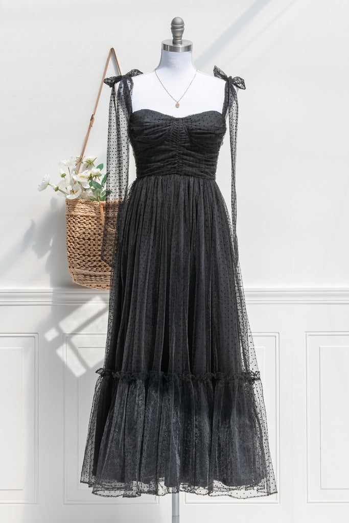 cute black cottagecore dress styled with a french tote and flowers. 