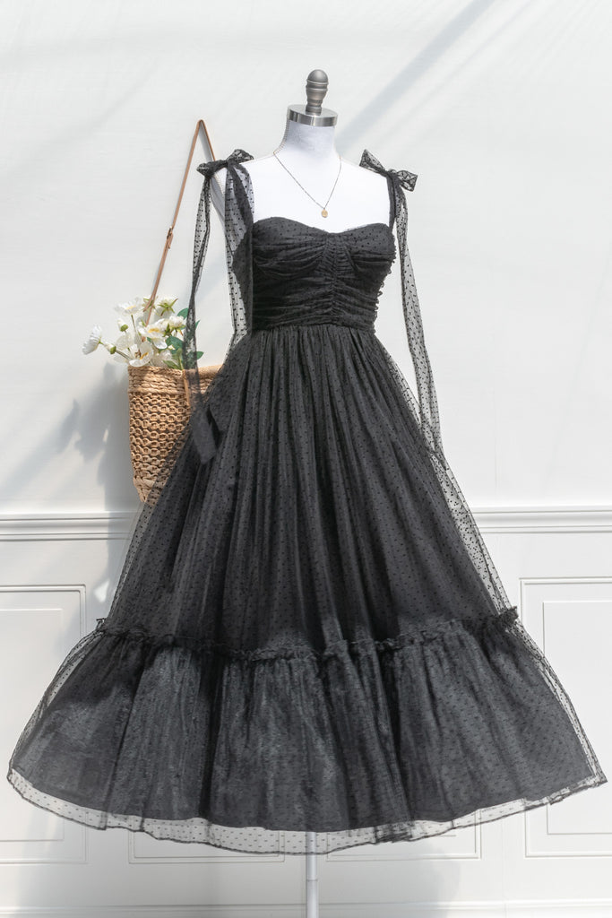 twirling cottagecore dress in black polka dot and structured bodice. Midi. Fall outfit style. front view. Amantine. 