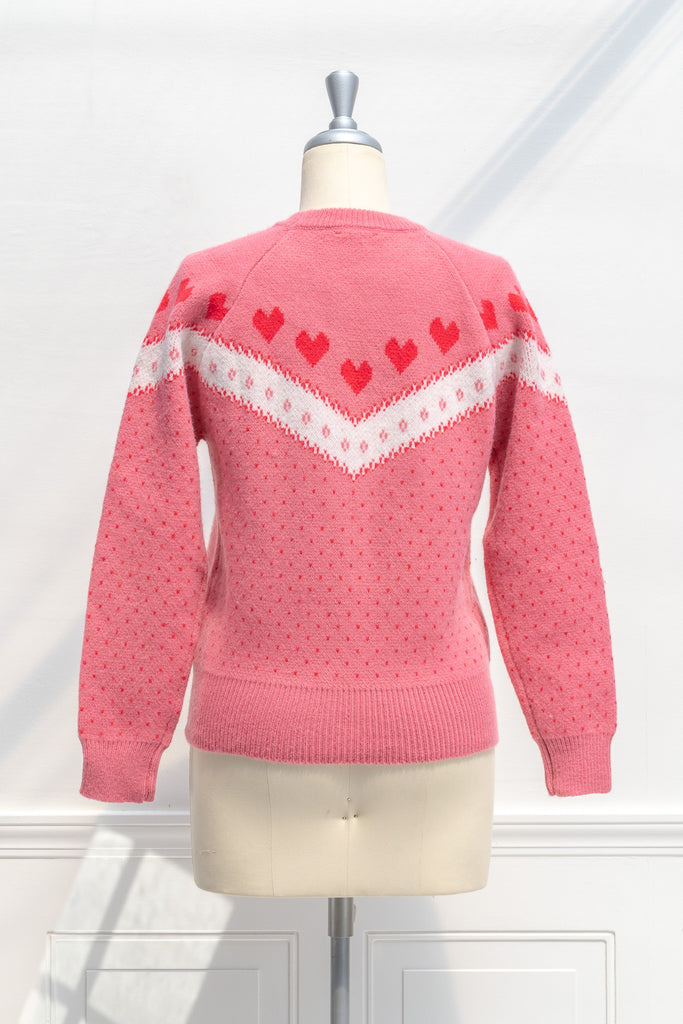 cute pink sweater with heart print. 