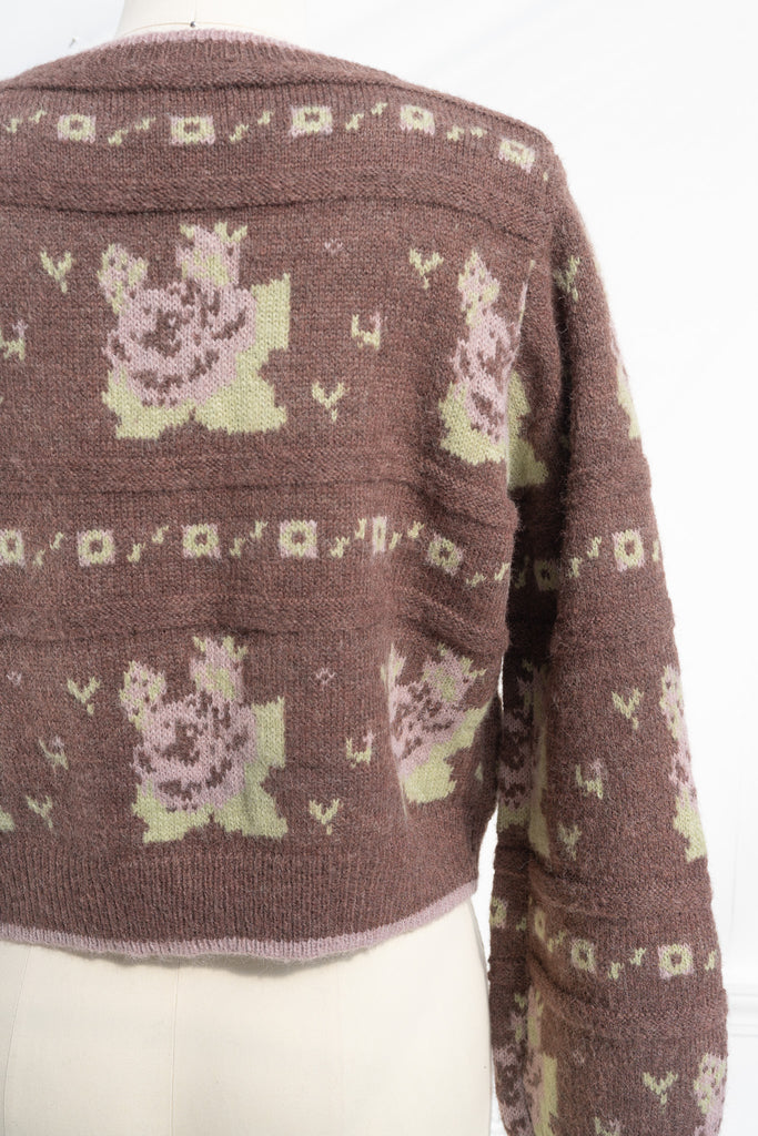 cute sweaters for fall. a floral abstract print light brown and green button down cardigan. back view. 