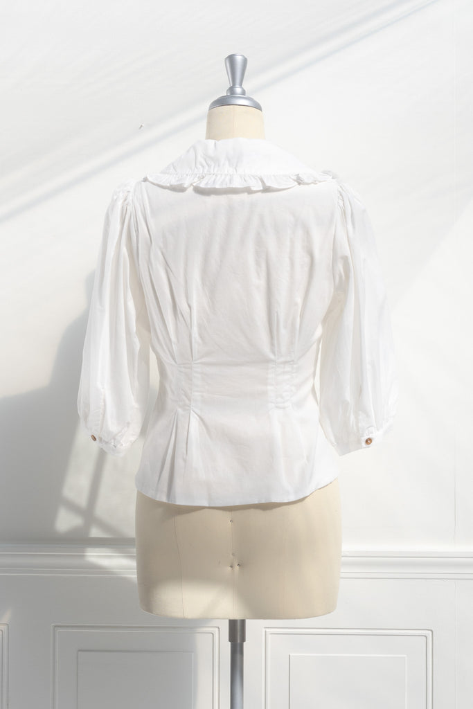 cute cottage core outfit - a cute peter pan collar white shirt. 3/4 sleeve, feminine details. back view. 