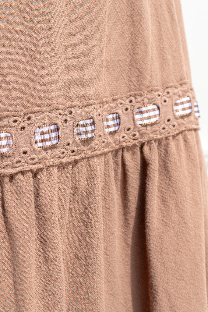 fabric detail showing color, lace, and gingham ribbon detail. 