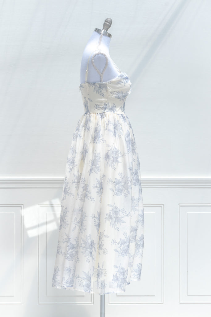 a cute boutique dress -a beautiful blue floral print organza, smocked elastic back, an a-line skirt with petticoat. side view. amantine. 