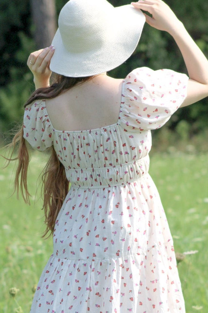 a cute floral chemise style dress. perfect for back to school dress outfits. girl wearing dress in field view. 