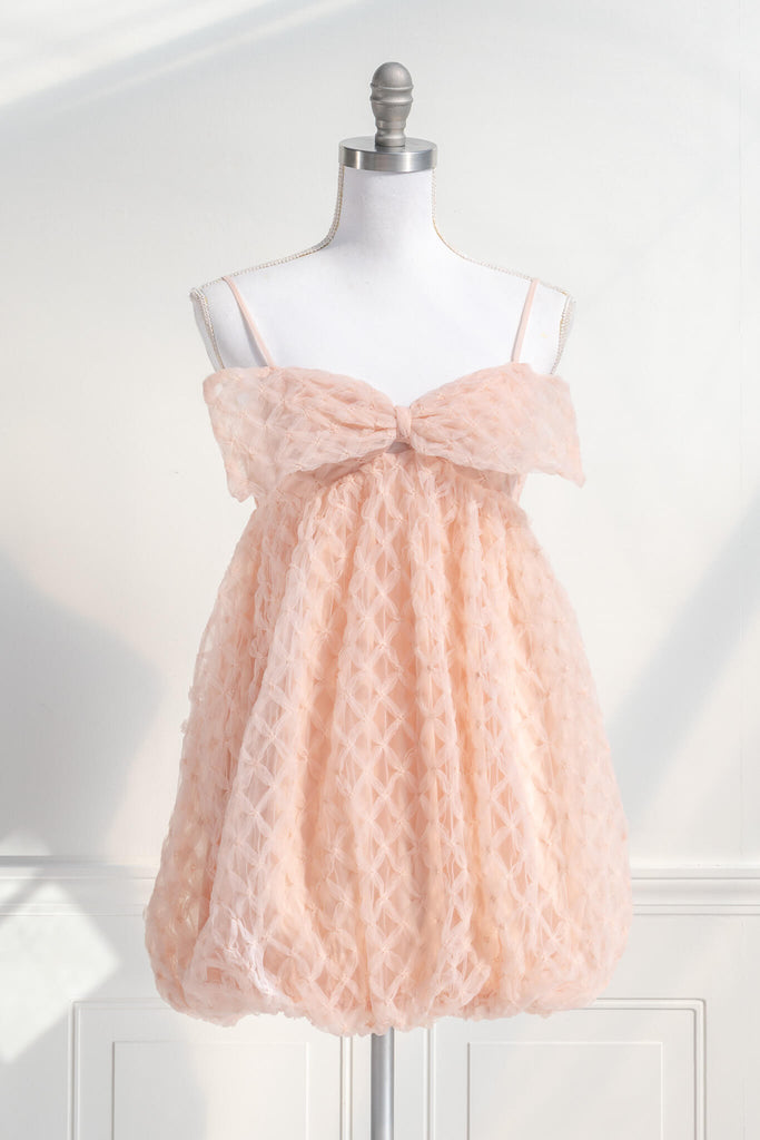 bow dress - a feminine dress with a bow in the front in pink and textured organza. Amantine. Front View. 