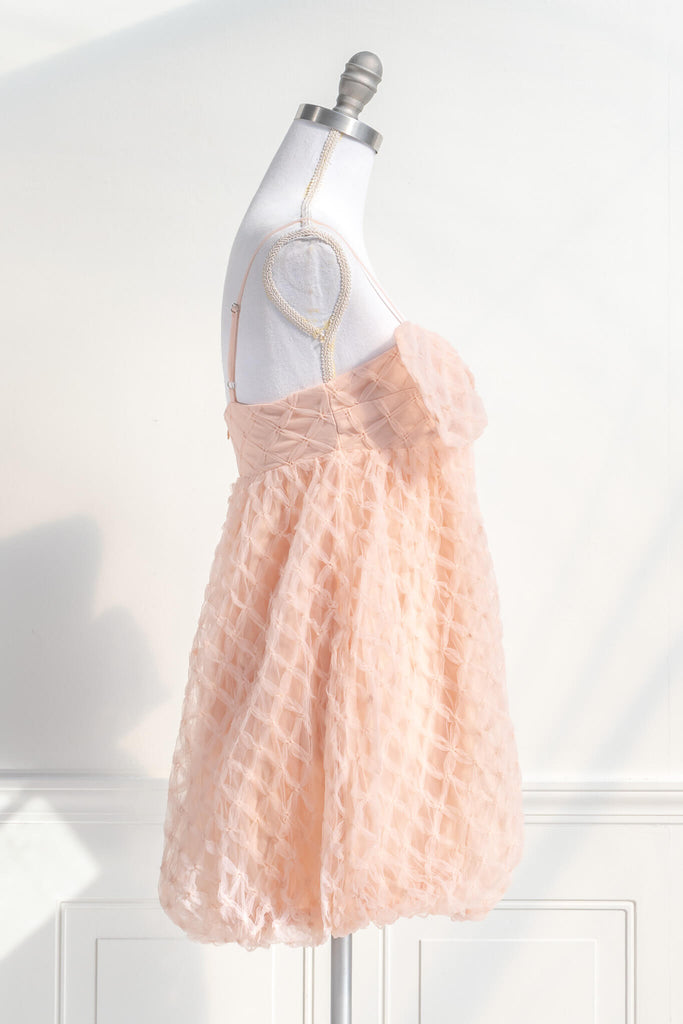bow dress - a feminine dress with a bow in the front in pink and textured organza. Amantine. side View. 