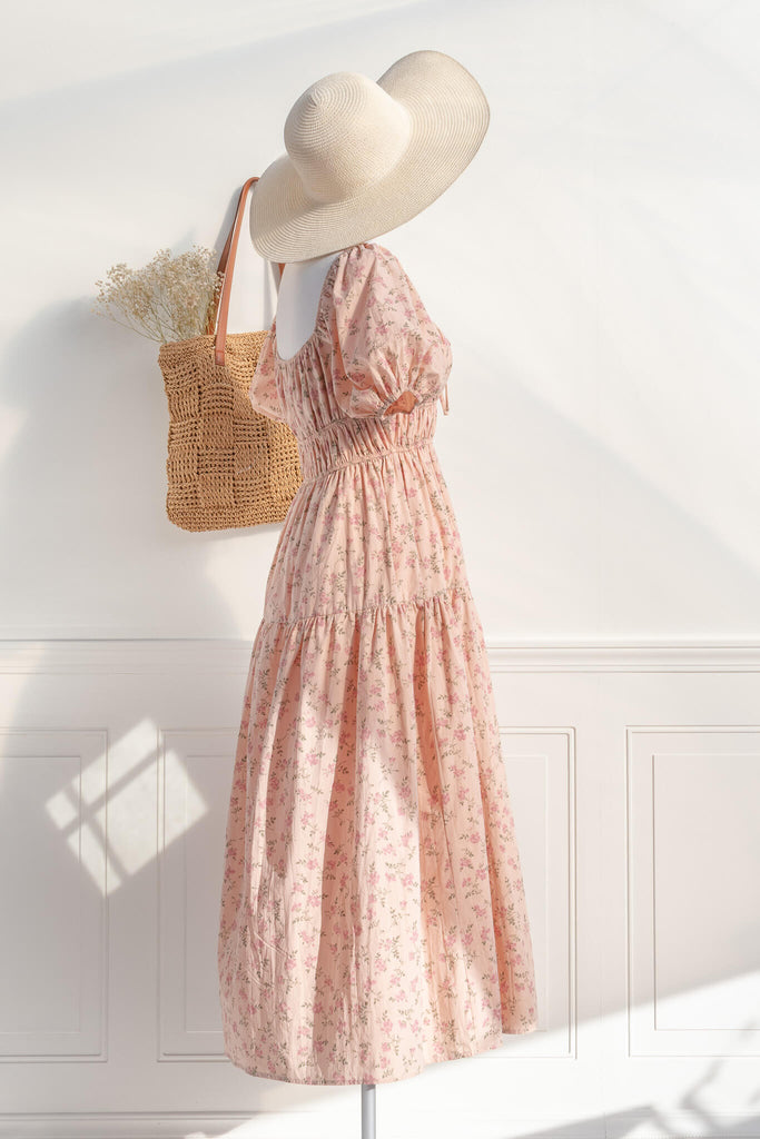cottagecore dress / peach fuzz dress.  a beautiful floral dress for spring with a square neckline, puff sleeves, and elastic waist. perfect for cottagecore dress goals. amantine - styled with a hat and a french market tote view.