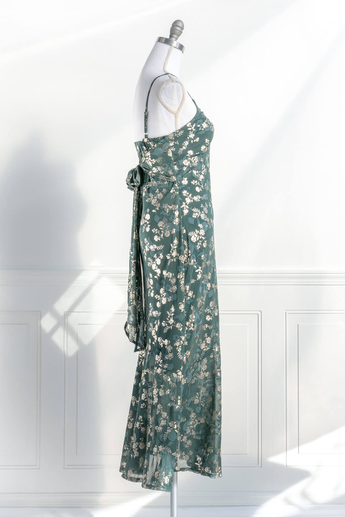 French dresses - inspired by feminine, elegant, cottagecore styles. A green dress with gold metallic floral detail. amantine dresses. side view. 