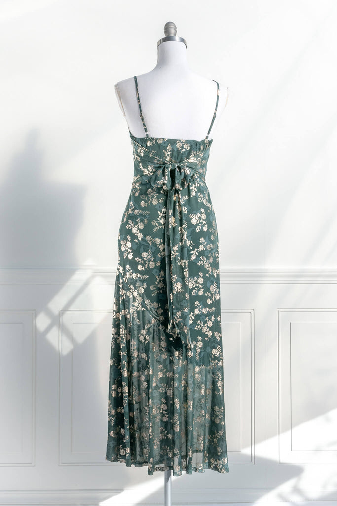French dresses - inspired by feminine, elegant, cottagecore styles. A green dress with gold metallic floral detail. amantine dresses. back view. 