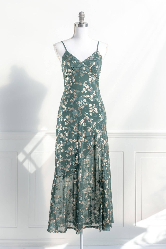 French dresses - inspired by feminine, elegant, cottagecore styles. A green dress with gold metallic floral detail. amantine dresses. front view. 