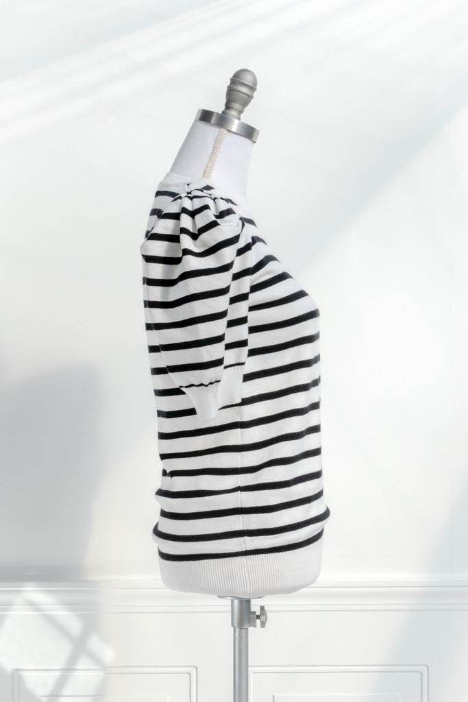 French striped top - feminine, and romantic classic french clothing. black and white pattern. side view. 