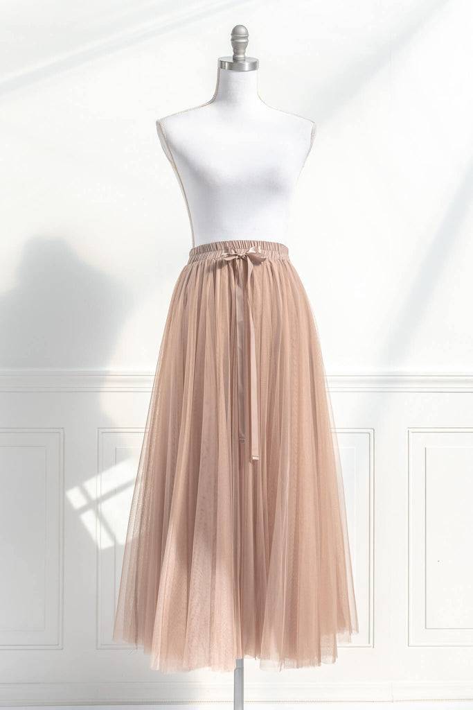 Feminine skirts - a long tulle skirt with a bow decorative closure, featuring two layers of tulle and a slip lining. amantine. front view. 