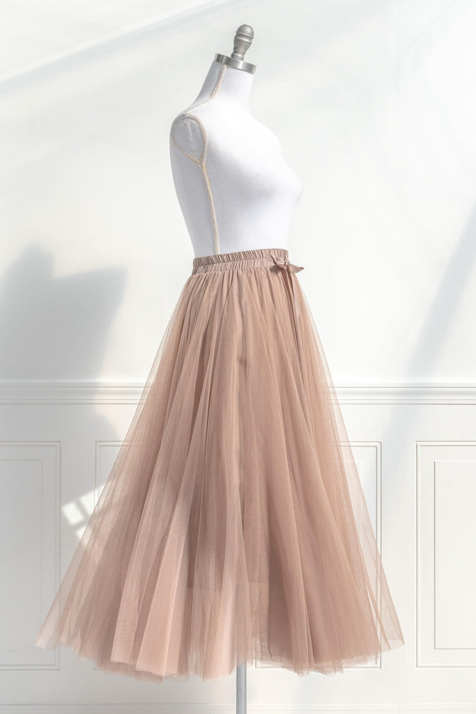 Feminine skirts - a long tulle skirt with a bow decorative closure, featuring two layers of tulle and a slip lining. amantine. quarter view. 