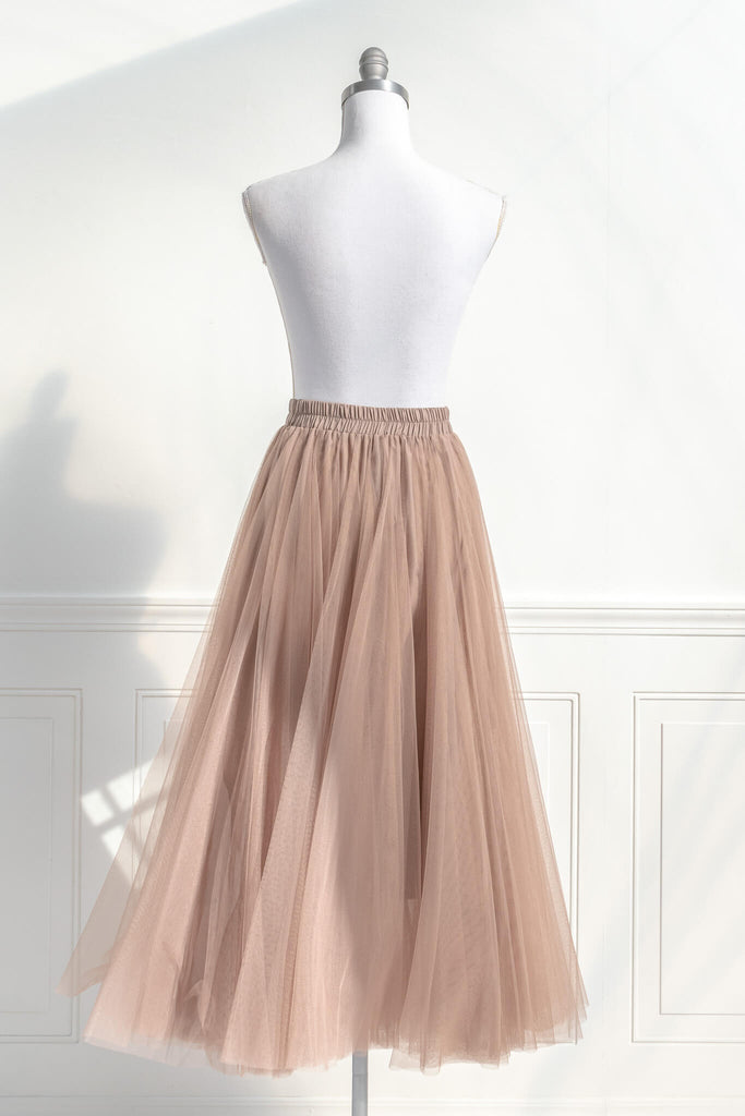 Feminine skirts - a long tulle skirt with a bow decorative closure, featuring two layers of tulle and a slip lining. amantine. back view. 