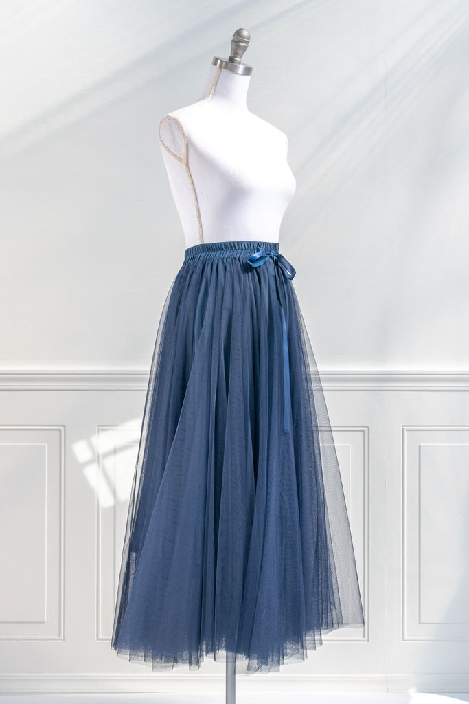 feminine clothing - a french style blue tulle maxi skirt. french girl skirt with bow. quarter side view. amantine.