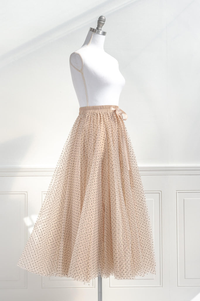 feminine clothing- a french style polka dot tulle maxi skirt. french girl skirt with bow. quarter side view. amantine.