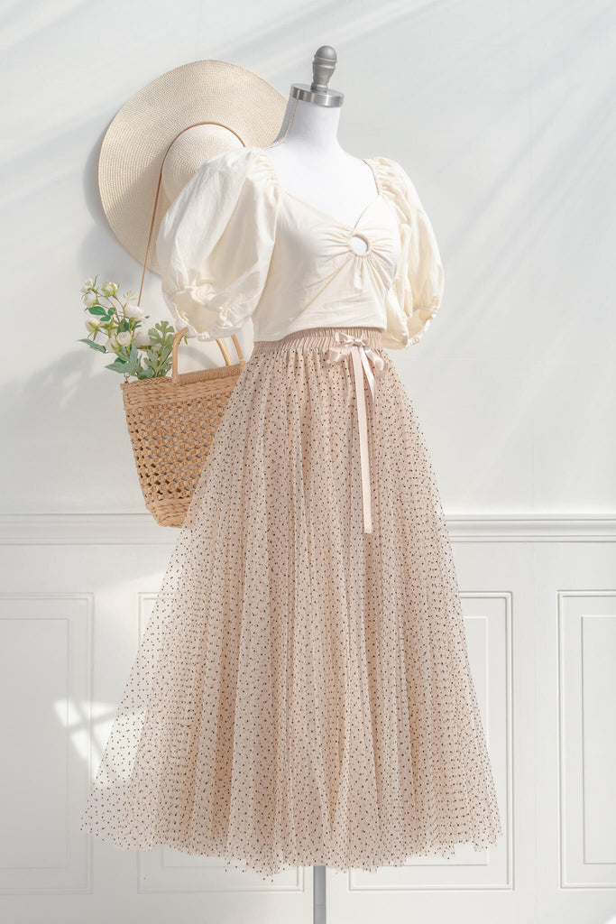 feminine clothing- a french style polka dot tulle maxi skirt. french girl skirt with bow. styled with feminine top view. amantine.