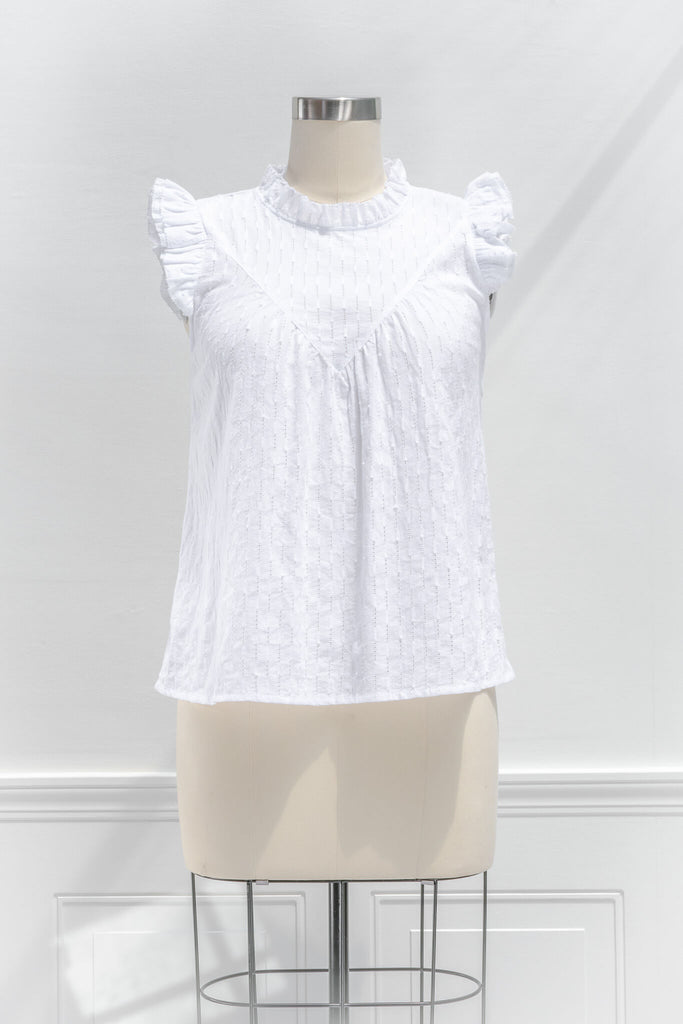 feminine tops - a cottagecore style white blouse with a ruffled crew neckline, ruffled sleeves, and white fabric. front view. 