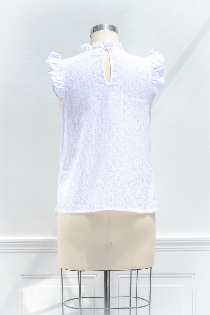 feminine tops - a cottagecore style white blouse with a ruffled crew neckline, ruffled sleeves, and white fabric. back view. 