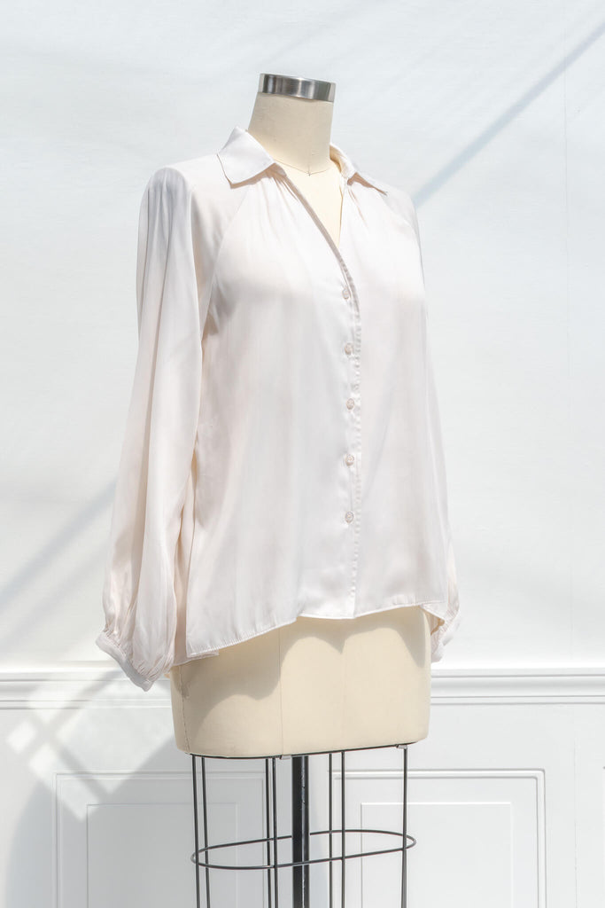 feminine blouses for work - a work appropriate beige button down dress shirt. quarter side view. 