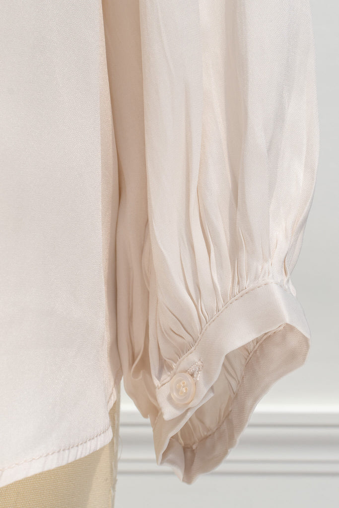 fabric detail up close, showing beige material soft to the touch in a silky way. 