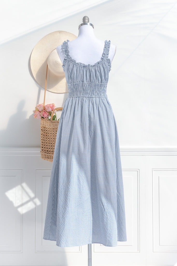 feminine and french inspired blue gingham dress. with ruffled straps, three bows, and pockets. perfect for cottagecore and french girl style ootd for spring. amantine. back view. 