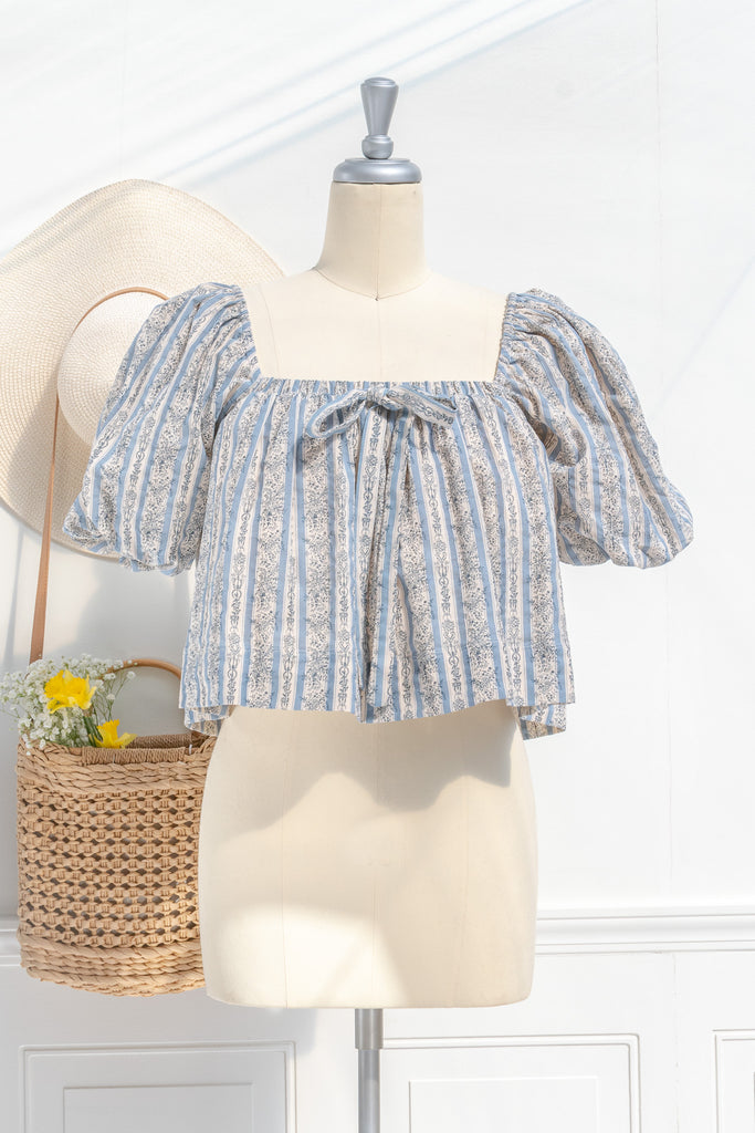 feminine tops - a cute feminine blouse in blue and gray floral detail. cotton, square neckline, puff sleeves. front view. 