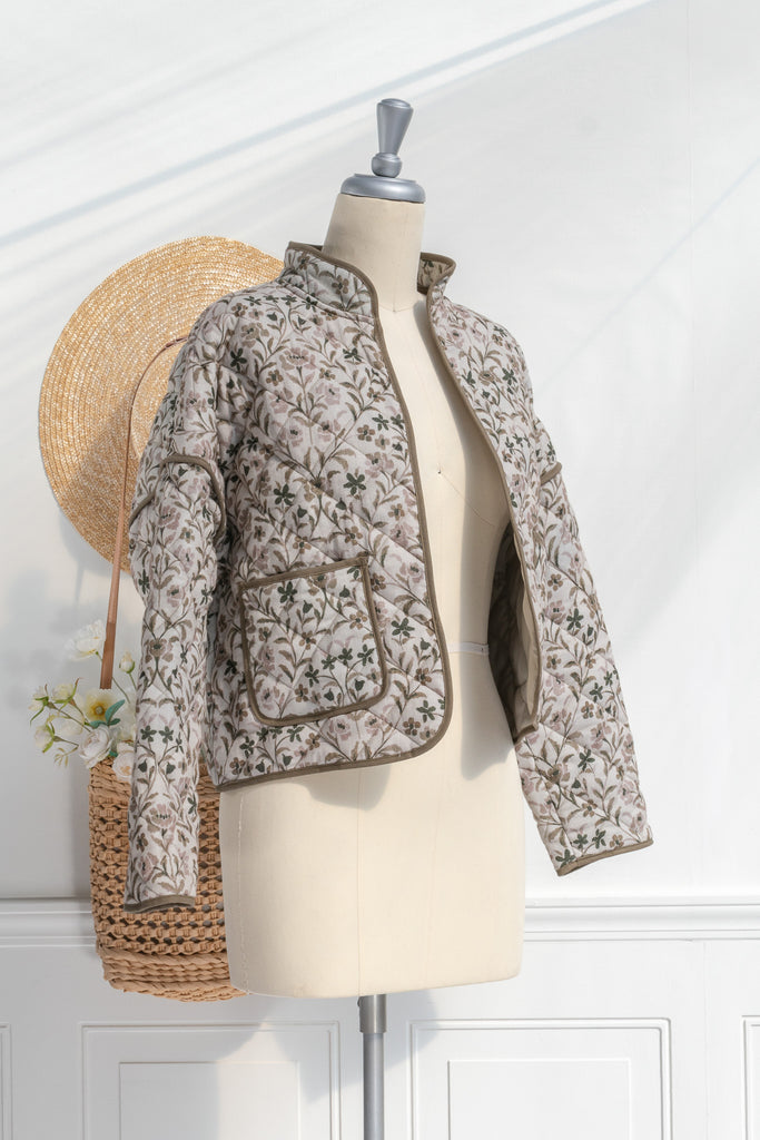 Feminine clothing - a beautiful light weight quilted floral jacket with pockets, dropped shoulders, and a very feminine style. Perfect for spring. 3/4 side view. Amantine.  