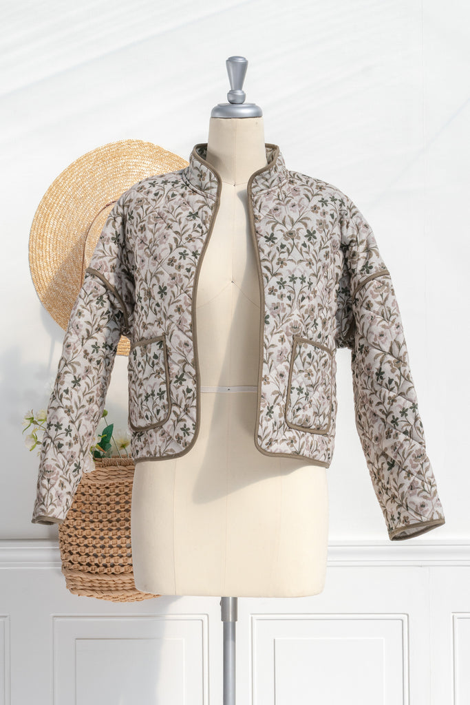 Feminine clothing - a beautiful light weight quilted floral jacket with pockets, dropped shoulders, and a very feminine style. Perfect for spring. front view. Amantine.  