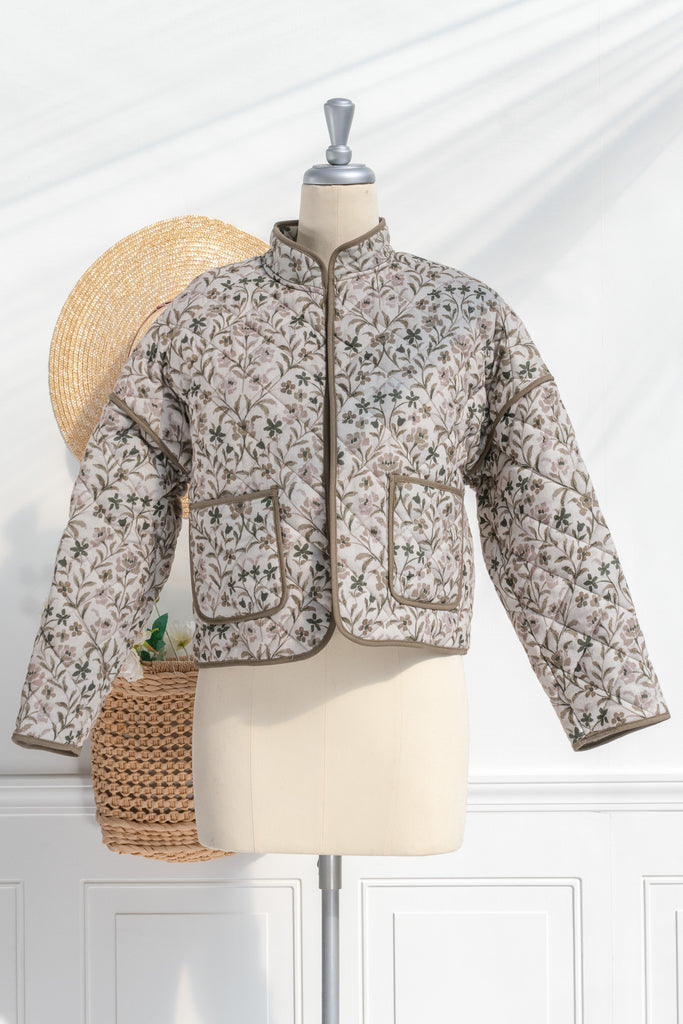 Feminine clothing - a beautiful light weight quilted floral jacket with pockets, dropped shoulders, and a very feminine style. Perfect for spring. 3/4 side view. Amantine.  