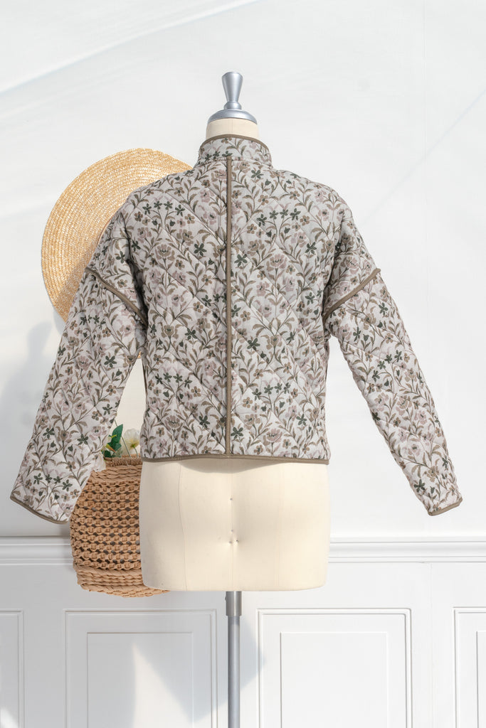 Feminine clothing - a beautiful light weight quilted floral jacket with pockets, dropped shoulders, and a very feminine style. Perfect for spring. back view. Amantine.  