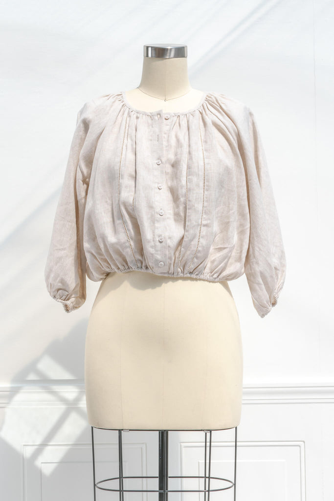 cottagecore outfits - a french and feminine style linen top for work. Button down, long sleeves, round neckline. Front view. 