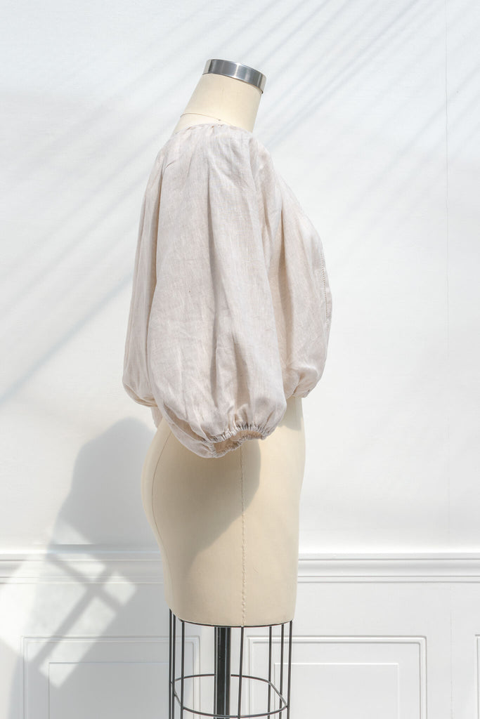 cottagecore outfits - a french and feminine style linen top for work. Button down, long sleeves, round neckline. side view. 