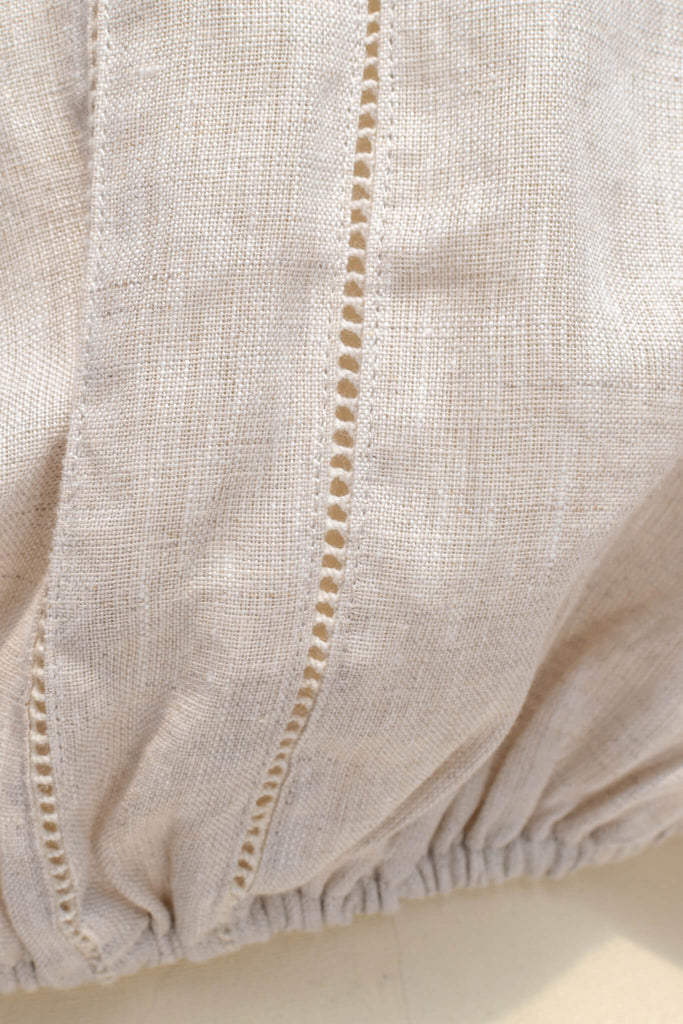 cottagecore style blouse for work. up close detail showing linen fabric with elastic band at the waist. 