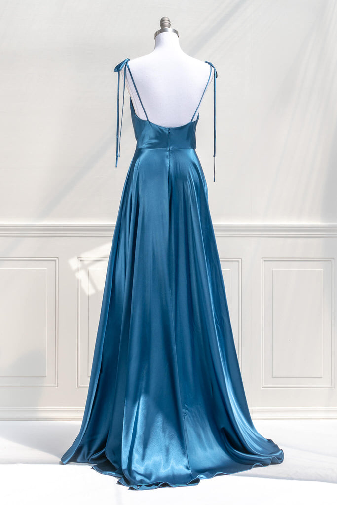 affordable formal gown for events. a long sapphire blue elegant formal dress with cowl neck and spaghetti straps. back view. Amantine. 